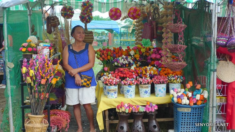 Smiling vendor selling colorful fossilized flowers. Bili na!
